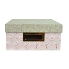 a pink and white storage box with flowers on the front, gold trim around the lid