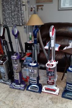 a bunch of vacuums that are sitting on the floor