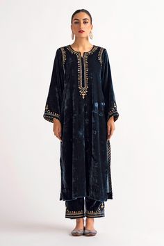 Deep blue velvet kurta, featuring longline hem in straight silhouette, highlighted with placement contrast hand embroidery. Paired with a straight pant.
Components: 2
Pattern: Placement Hand Embroidery
Type Of Work: Sequin, Zari, Flower
Neckline: Notched Round Neck
Sleeve Type: Full Sleeves
Fabric: Velvet
Color: Blue
Other Details: 
Floral hand embroidery on the back of the kurta
Placement floral hand embroidered pant
Occasion: Puja,Mehendi and Haldi - Aza Fashions Velvet Suit Design, Ramadan 2024, Velvet Kurta, Velvet Dress Designs, Pant For Women, Pakistani Clothes, Velvet Suit, Embroidered Pants, Suits Design