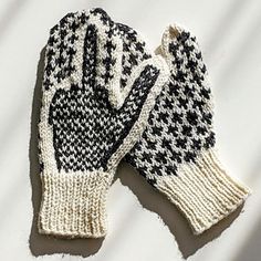 a pair of black and white knitted gloves