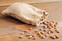 a bag filled with nuts sitting on top of a wooden floor