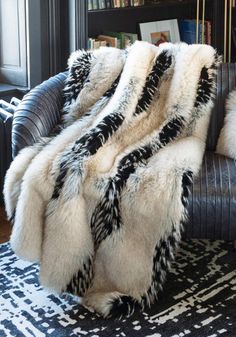 Aaaaaaahhhhhh - that's you, at the end of a long, stress-filled day, relaxing under an Ivory Fox throw. New in our Limited Edition Collection of faux fur throws, you'll love the lure of this warm, dramatic fur that works in many room settings.  A trifecta of color, texture and toning, Ivory Fox is an exciting combination of warm Ivory and pale Taupe with Ebony highlights and subtle tipping. Believably beautiful and amazingly authentic, guard hairs add to the authenticity of this extravagantly luxurious cruelty-free replica. At home in both contemporary and transitional settings, the luxe, lush vibe belies the fact that Ivory Fox throws are amazingly practical! Though luxuriously lined in velvet, Ivory Fox throws are meant to be used and enjoyed, thanks to the convenience of machine wash/li Fur Rugs Living Room, Black Glam Living Room, Fur Rug Living Room, Moody Room, Mom Cave, Medieval Wedding Dress, Fur Rugs, Fur Bedding, Romantic Bedroom Decor