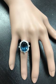 12.75 Carats Natural Impressive LONDON BLUE TOPAZ and Diamond 14K White Gold Ring Suggested Replacement Value $6,200.00 Total Natural London Blue Topaz Weight: Approx. 12.00 Carats London Blue Topaz Measures: Approx. 15 x 11mm Natural Round Diamonds Weight: .75 Carats (color G-H / Clarity SI1-SI2) Ring total weight: 9.0 grams Disclaimer: all weights, measurements and colors are approximate and may vary slightly from the listed dimensions or as seen in the image. All pictures are magnified to sho Luxury Platinum Topaz Ring With Accent Stones, Luxury Blue Topaz Ring With Diamond Accents, Luxury Blue Topaz Cushion Cut Ring, Luxury Formal Blue Topaz Diamond Ring, Luxury Blue Topaz Diamond Ring For Formal Occasions, Formal Blue Brilliant Cut Gemstones, Blue Brilliant Cut Gemstones For Formal Occasions, Luxury Platinum Topaz Gemstone Ring, Luxury Cushion Cut Diamond Topaz Ring