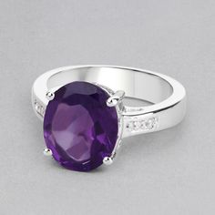 "Amethyst Ring, Natural Amethyst Ring, Amethyst Cocktail Ring, Amethyst Oval, Promise Ring, Sterling Silver Ring, February Birthstone Ring Flaunt yourself with this amethyst & white topaz cocktail ring. The natural gemstones have a combined weight of 3.84 carats and are set in .925 sterling silver with rhodium plating. The purple hue of this ring adds a pop of color to any look! The understated design and vibrant stones make this ring perfect for every occasion. .925 Sterling Silver Stone De Purple Oval Crystal Ring With Gemstone, Oval Amethyst Crystal Ring With Accent Stones, Amethyst Crystal Ring With Accent Stones, Fine Jewelry Purple Oval Crystal Ring, Oval Purple Diamond Ring With Gemstone Accents, Purple Crystal Ring With Oval Center Stone, Oval Amethyst Ring With Gemstone Accents For Promise, Oval Amethyst Ring With Center Stone, Oval Amethyst Diamond Promise Ring