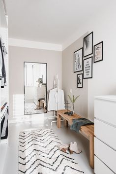 a room with white walls and pictures on the wall