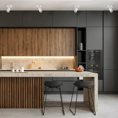 a modern kitchen with two stools next to the counter and an island in front of it