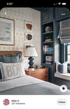 a bed room with a neatly made bed next to a book shelf filled with books