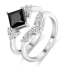 two white gold rings with black and white diamonds on each side, one has a princess cut