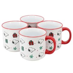 four red and white coffee mugs with snoopy christmas designs