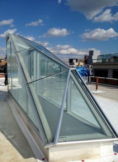 a glass walkway on the roof of a building