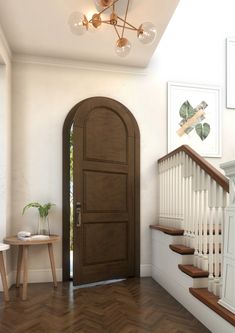 an entryway with stairs and a wooden door