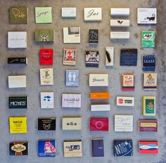 many different types of business cards are arranged on a concrete surface, including one for each individual