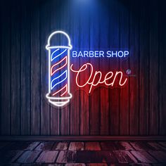 barber shop open neon sign on wooden wall with red and blue lights in the background