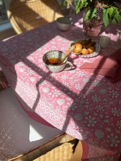 the table is covered with pink and white cloths