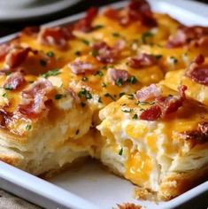 a close up of a plate of food with cheese and bacon on it's crust