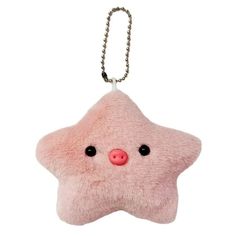 a pink star shaped keychain with black eyes and a nose on the front