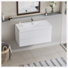 a white sink sitting under a mirror in a bathroom