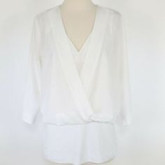 Cabi | White Indulge Top 3/4 Sleeve (Size: Xl) -Blouse -3/4 Sleeve -V Neck -Faux Wrap -Back: Zipper Closure -Material: Top 100% Polyester Bottom Piece: 67% Rayon, 28% Nylon, 5% Spandex -Color: White -Size: X-Large -Pit To Pit: 27" -Waist: 19" -Sleeves: 19" -Nwot: New Without Tags White 3/4 Sleeve Tops For Layering, Elegant 3/4 Sleeve Blouse For Brunch, White 3/4 Sleeve Blouse For Work, Elegant 3/4 Sleeve Tops For Brunch, Elegant Half Sleeve Tops For Brunch, Chic 3/4 Sleeve Tops For Layering, Elegant Top With 3/4 Sleeves For Daywear, Spring Floral Blouse, Leopard Print Cami