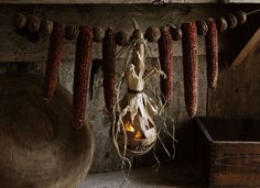 corn hanging from the ceiling in an old barn