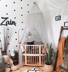 a baby's room with polka dot wallpaper and wooden crib in the corner