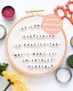 a cross stitch pattern with words on it and some scissors next to it, along with other crafting supplies