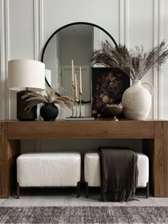 a wooden table topped with vases and lamps