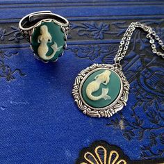 "18x13mm teal resin mermaid cameo in an antiqued silver or antiqued brass setting. On 18\" of chain but any other length can be requested at checkout. I also have a matching ring and bracelet in my shop (shown in last photos)." Resin Mermaid, Christmas Gifts For Teens, Pirate Mermaid, Pisces Jewelry, Aquarius Gifts, Easter Basket Stuffers, The Poison, Cameo Jewelry, Cameo Ring