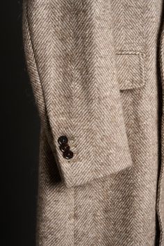 A handmade bespoke overcoat crafted from a luxurious fabric with a unique blend of fibers (wool, alpaca, mohair, silk and nylon) to give you the ultimate do-it-all coat. Wool gives it lasting performance and versatility. Alpaca gives it softness and warmth. Mohair gives it a crisp drape with natural wrinkle-resistance. Silk gives it a luster and natural sheen. And nylon gives it strength and durability to last the test of time. You will love this coat - it will elevated your entire wardrobe and you will wear it for many years to come. Luxury Single Breasted Beige Wool Coat, Luxury Beige Single Breasted Wool Coat, Luxury Beige Wool Coat With Concealed Placket, Beige Long Wool Coat With Concealed Placket, Business Cream Wool Coat, Luxury Long Beige Wool Coat, Elegant Brown Tweed Wool Coat, Classic Wool Coat With Herringbone Pattern, Luxury Brown Wool Coat With Notch Lapel