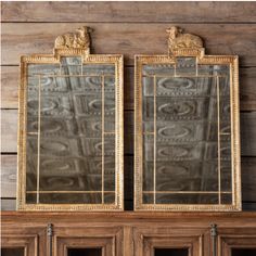 two mirrors sitting on top of a wooden shelf