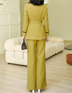 This elegant mustard pantsuit comes with a waist-sash blazer and flare-bottom pants for a sophisticated aesthetic that can be styled in endless ways. Black trim on collars and sleeves Blazer: Lined, double-breasted button closure Blazer: Long sleeves, shawl collar, front flap pockets Pants: Zip fly with hook-and-button closure Pants: Front slant pockets 50% wool,50% polyester Dry Clean Item #2816 Women's blazer & pant two-piece set SIZE INFO XS=US2=UK6=EU32 S=US4-6=UK8-10=EU34-36 M=US8-10=UK12-1 Chic Solid Suits For Fall, Chic Solid Color Fall Suits, Chic Fall Suits In Solid Color, Cream Long Sleeve Wool Coat For Work, Beige Single Breasted Suit For Fall, Beige Wool Long Sleeve Suit, Beige Single-breasted Suit For Fall, Beige Single-breasted Fall Suit, Beige Long Sleeve Tweed Jacket For Office