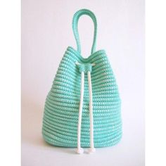 a handbag made out of woven material with a white string hanging from the handle