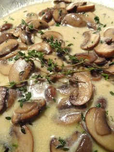 a pan filled with mushroom soup and garnished with parsley