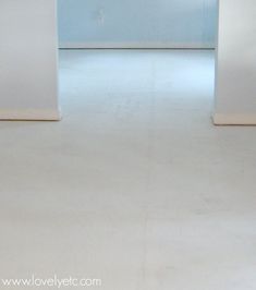 an empty room with white walls and floors