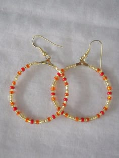 Warm coloured hoop earrings The hoops face the front Hoops are approx. 3 cm in diameter Red Small Hoop Earrings, Orange Small Hoop Earrings For Gift, Small Hoop Earrings Orange Gift, Small Hoop Earrings Orange For Gift, Small Hoop Earrings In Orange For Gifts, Adjustable Orange Hoop Earrings, Orange Small Hoop Earrings With Ear Wire, Orange Hoop Beaded Earrings As Gift, Making Earrings