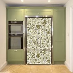 a kitchen with green cabinets and an ornate glass door refrigerator freezer combo in the center