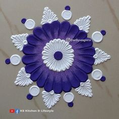 a purple and white flower with circles on the center is surrounded by other circular objects