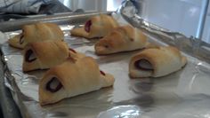 pigs in a blanket sitting on top of aluminum foil