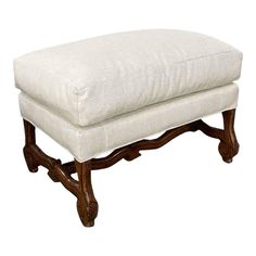 a white foot stool sitting on top of a wooden frame