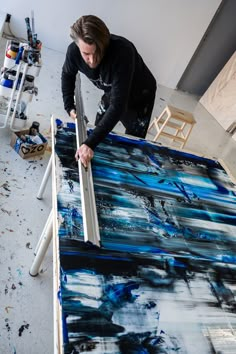 a man is working on an abstract painting