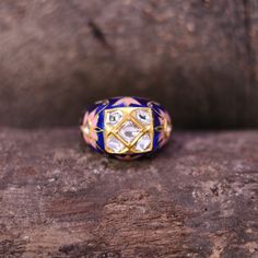 This design is a perfect epitome of the Mughal era. This Unique, One of a Kind Mughal ring is handcrafted in 22k Gold with impeccable enameling. There are beautiful flowers, the most preferred motif in Mughal enameling. The design of this vintage piece of jewelry has been inspired by the Royal Jewelry collections of the Maharajas. The ring is embellished with Natural conflict-free Rosecut Diamonds also known as Diamond Polkis. Polki diamonds are one of the oldest forms of cut diamonds. They are Enamel Gemstone Rings For Wedding, Wedding Rings With Gemstone And Enamel, Yellow Gold Enamel Gemstone Ring For Wedding, Heirloom Yellow Gold Enamel Ring For Ceremonial Occasions, Traditional Hallmarked Engraved Ceremonial Ring, Enamel Open Rings For Wedding, Traditional Diamond Ring Gift, Traditional Gemstone Open Ring, Traditional Rose Cut Diamond Ring For Formal Occasions