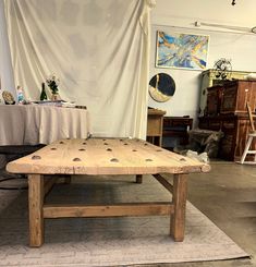 a wooden table sitting on top of a rug