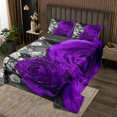 a bed with purple flowers on it in a room