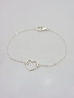 REAL STERLING SILVER - A QUALITY PIECEThis is an original design by The Violet Goat. I make this beautiful bracelet using a sterling silver heart charm set on sturdy sterling silver chain (all 925 sterling). Secures with a lobster clasp and comes in a gift box. These make great group gifts. Heart measures approximately 1/2 inch.FEATURED ON WOMAN'S DAY WEBSITE: This little beauty had the honor of being featured on several different sites, including a gift guide article for Woman's Day. This origi Minimalist Open Heart Bracelet As Gift, Minimalist Sterling Silver Heart Bracelet For Mother's Day, Dainty Open Heart Everyday Bracelets, Sterling Silver Double Heart Bracelet For Everyday Wear, Minimalist Silver Double Heart Bracelets, Adjustable Delicate Sterling Silver Heart Bracelet, Everyday Sterling Silver Double Heart Bracelet, Everyday Double Heart Sterling Silver Bracelet, Minimalist Open Heart Bracelet With Heart Charm