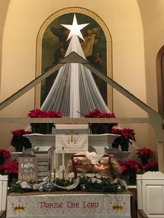 the altar is decorated with poinsettis and christmas decorations