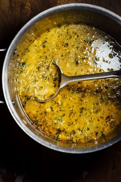 a pot filled with soup and a spoon in it