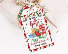 a teacher's gift tag is tied to a white present box with twine ribbons