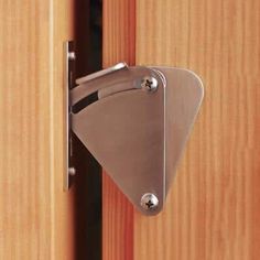 a close up of a door handle on a wooden door with wood grained doors