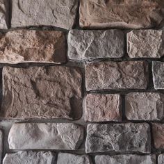 a stone wall that is made out of different types of rocks