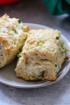 two pieces of broccoli and cheese scones on a plate