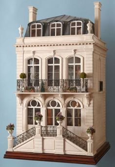 a doll house with balconies and windows